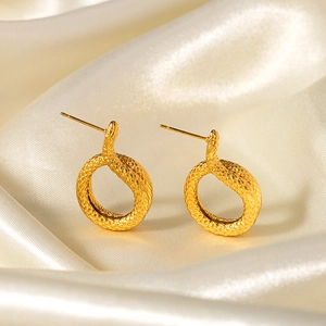 18k gold plated stainless steel snake stud earrings with textured scale pattern on silk