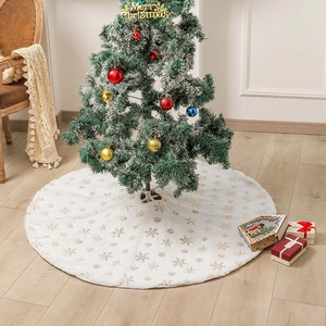 White plush Christmas tree skirt with gold snowflake sequins and festive holiday decor