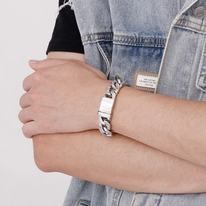 Close-up of hip hop silver iced out Cuban chain bracelet with crystal details on arm