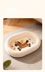 Detail of soft plush oval cat bed with festive horse embroidery on a wooden floor