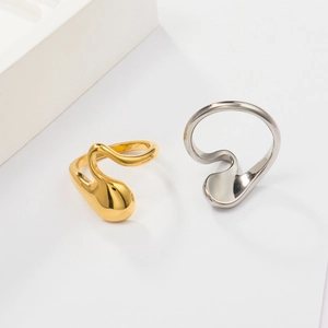 Detail view of streamlined water drop rings in 18K gold and silver stainless steel finish