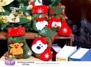 Detail view of rustic Christmas stockings with Santa and reindeer on wooden shelf