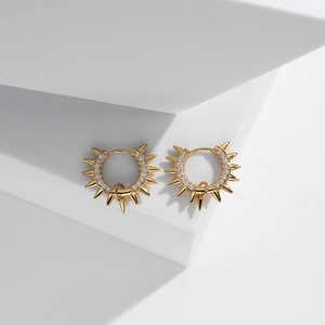 Detailed view of gold s925 silver rivet hoop earrings with sparkling white zircons