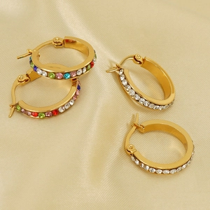 Detailed macro view of 18K gold-plated hoop earrings with colorful inlaid crystals