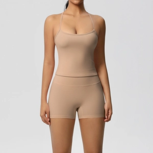 Detail of light beige two-piece yoga set with slim camisole top and high-waist fitness shorts