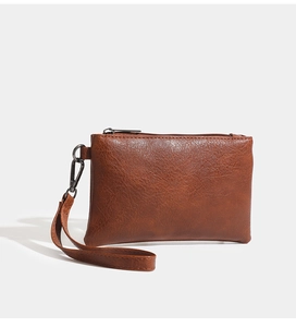 Close-up of litchi pattern PU leather wristlet wallet with metal zipper and strap