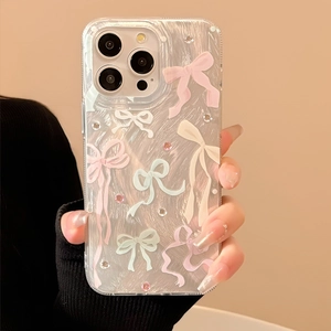 Detail of iPhone case with iridescent shell texture and pink bow rhinestones