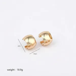 Detailed view of irregular polished gold hoop earrings with secure snap closure
