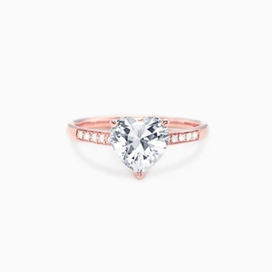Detail of rose gold ring with heart-cut pink zircon and side accent diamonds