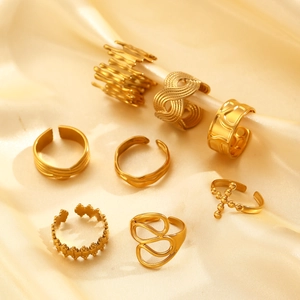 Collection of irregular gold stainless steel open rings on champagne silk fabric