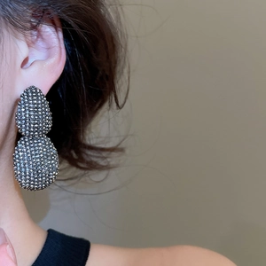 Macro shot of double teardrop stud earrings with pavé grey rhinestones in vintage style