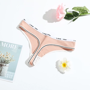 Flat lay of pink ribbed cotton thong with LOVE YOU waistband and floral accents