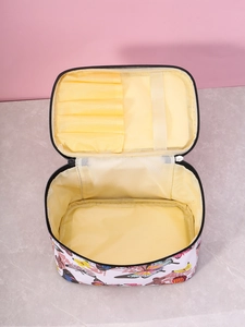 Internal view of square butterfly makeup bag with yellow lining and brush slots