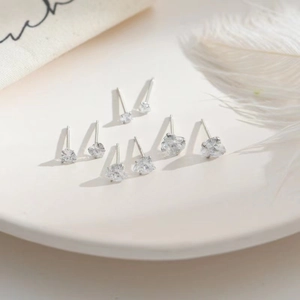 Detailed macro view of minimalist heart-shaped S925 sterling silver mini stud earrings