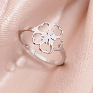 Minimalist silver clover cutout stainless steel adjustable ring on pink silk fabric