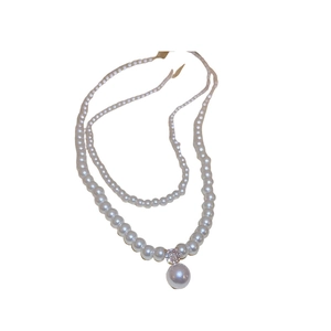 Elegant multi-layer pearl necklace with a teardrop pendant and zircon accents on white background