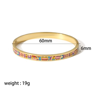 Detail view of 18k gold plated stainless steel bangle with 60mm diameter and enamel patterns