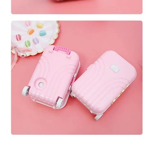 Macro detail of pink mini suitcase storage boxes with tiny wheels and YALIS logo