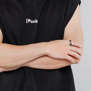 Close-up of a vintage black stainless steel razor ring on finger for a punk style look