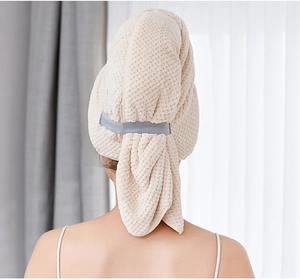 Detail of coral fleece hair towel with elastic strap for secure drying on the back of head