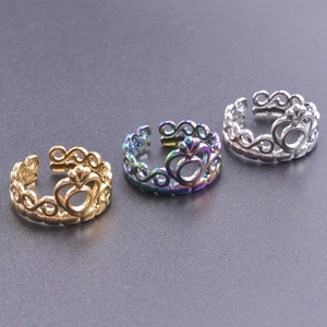 Detailed view of three adjustable crown rings in gold, rainbow, and silver steel finishes