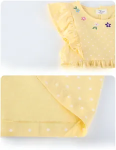Detail of yellow polka dot dress with floral embroidery and ruffled lace sleeves