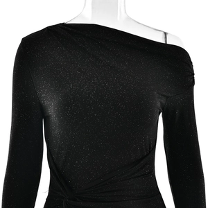 Detail of black one-shoulder glitter dress showing ruched waist and shimmering fabric