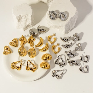 Collection of 18K gold and silver plated titanium steel geometric earrings on white stone