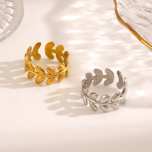 Gold and silver stainless steel leaf rings with adjustable open design in soft sunlight