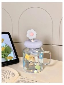 Close-up of glass straw cup with purple lid featuring flower patterns and 925 logo
