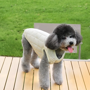 Close-up of beige quilted dog vest showing detailed diamond stitching on the fabric