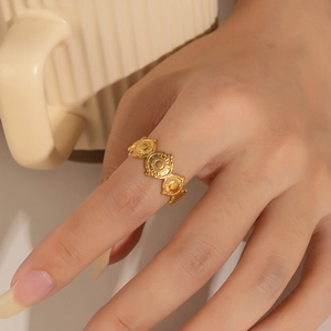 Close-up of golden hollow star ring with diamond accents worn on model finger