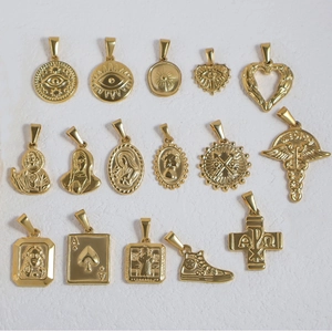 Macro view of 16 assorted vintage 24K gold plated stainless steel charms and pendants