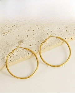 Detail of large 18K gold-plated stainless steel hoop earrings with latch-back closure