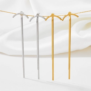 Modern gold and silver fringe earrings with long metal tassel in minimalist design