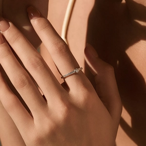 Moissanite bubble ring in rose gold finish on model finger with elegant lighting