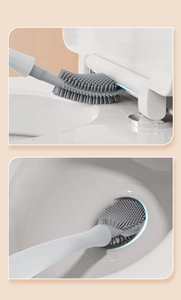 Detail of flexible grey silicone toilet brush cleaning rim gaps and inner pipe walls