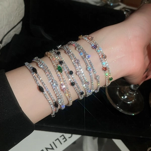 Close-up of sparkling 18k gold plated double-layer zircon bracelets on wrist
