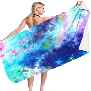 Detail of oversized microfiber beach towel showing vibrant tie-dye pattern and soft texture