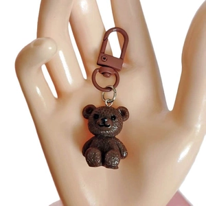 Brown resin cartoon bear keychain with matching matte metal clasp on white background