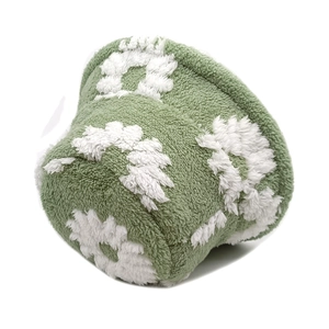 Detail showing plush teddy fleece texture and white 3D flower pattern on green bucket hat