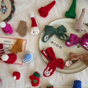 Close-up of colorful knitted Christmas hats and bows for DIY holiday decorations