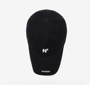Top view of a black baseball cap with white N embroidery and Nothing text on the brim