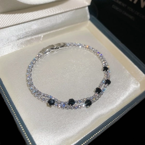 Detailed view of a sparkling 18k gold plated zircon double-layer bracelet in a gift box.