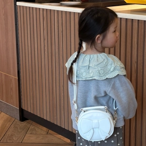 Cute white round crossbody bag for girls with large bow detail and adjustable strap