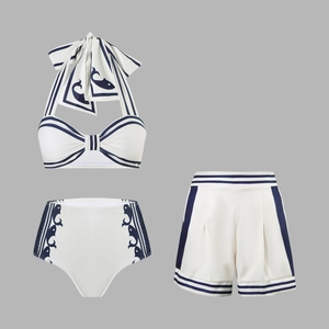 Detailed flat lay of three-piece navy stripe halter swimwear set with matching shorts