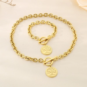 Close-up of gold chain jewelry set featuring Tree of Life pendants and T-bar clasps
