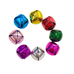 Colorful vacuum plated metal Christmas pet bells in circular arrangement on white background