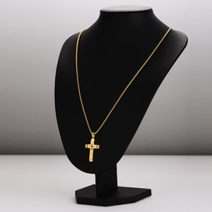Minimalist gold stainless steel cross necklace with embossed pendant on mannequin