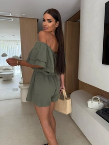 Detail of army green off-shoulder jumpsuit showing textured cotton ruffle sleeve design
